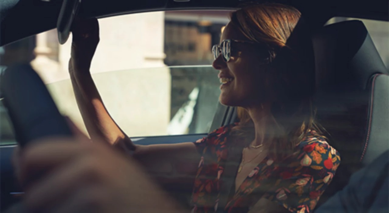 Smiling woman inside car